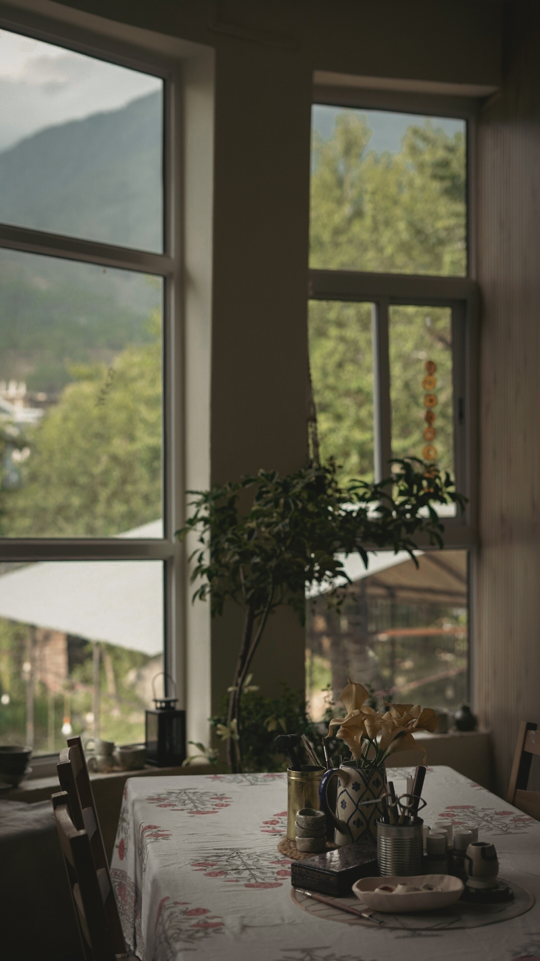 Studio table with tools and Dhauladhar mountains through the window